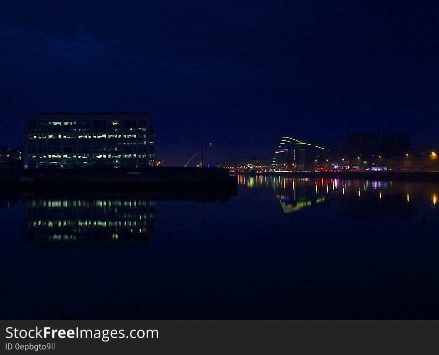 Waterfront in Dublin, Ireland illuminated at night reflecting in water. Waterfront in Dublin, Ireland illuminated at night reflecting in water.