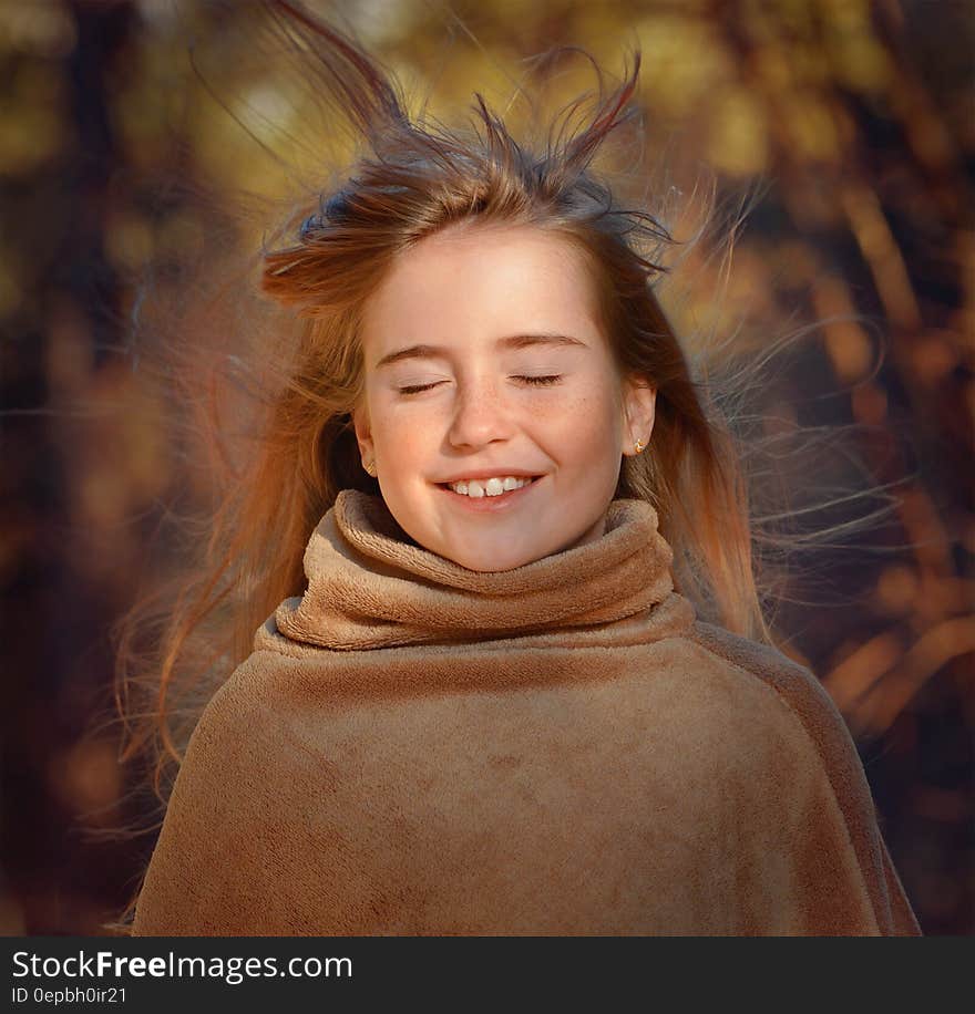 Smiling young girl in brown sweater outdoor in fall portrait. Smiling young girl in brown sweater outdoor in fall portrait.