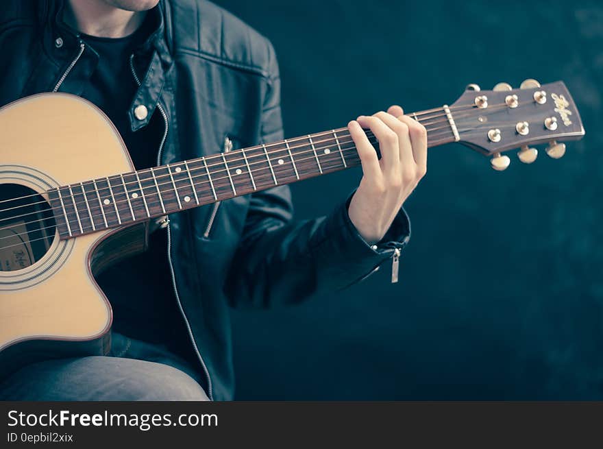 Close up of musician holding and playing acoustic guitar. Close up of musician holding and playing acoustic guitar.