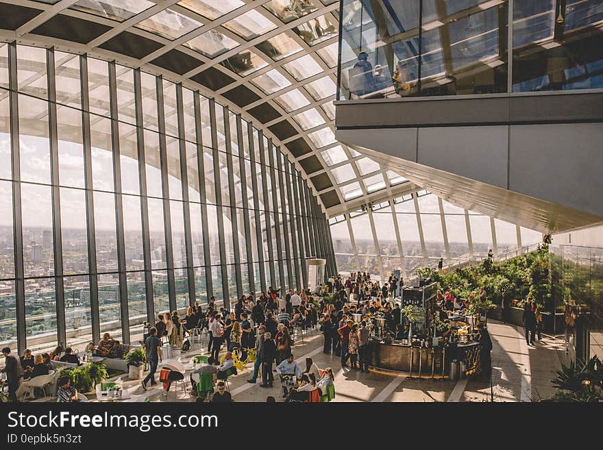 Interior restaurant at 20 Fenchurch in London, England with patrons on sunny day. Interior restaurant at 20 Fenchurch in London, England with patrons on sunny day.