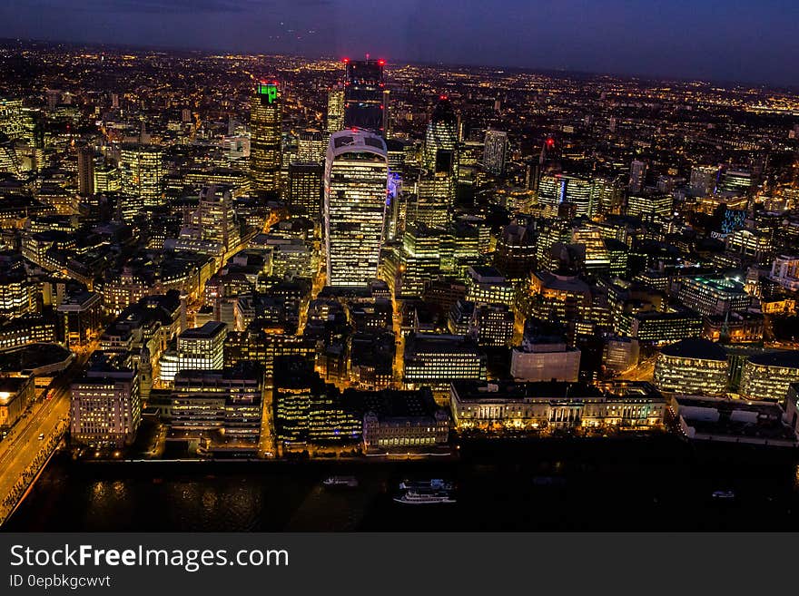 Aerial view of city skyline illuminated at night.