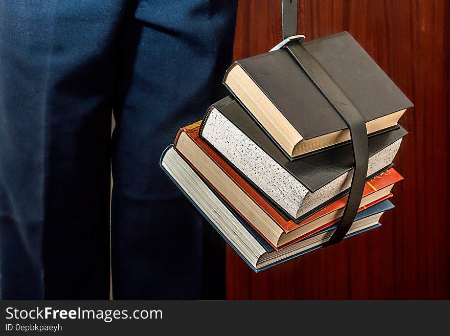 Black Leather Book Strapped Around Four Books