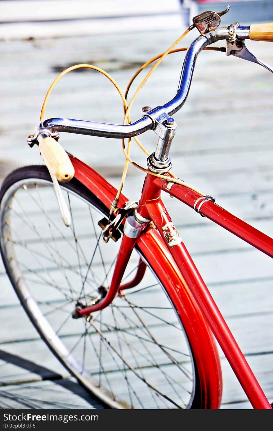 Close up of front fender, tire and handlebars on bicycle on boardwalk outdoors. Close up of front fender, tire and handlebars on bicycle on boardwalk outdoors.