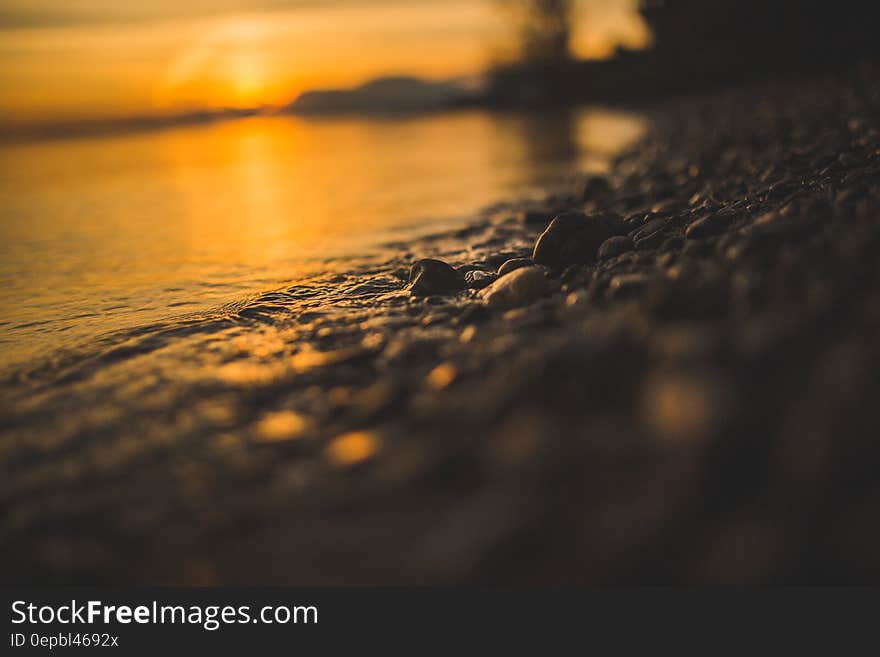 Close up of pebbles on beach at sunset. Close up of pebbles on beach at sunset.