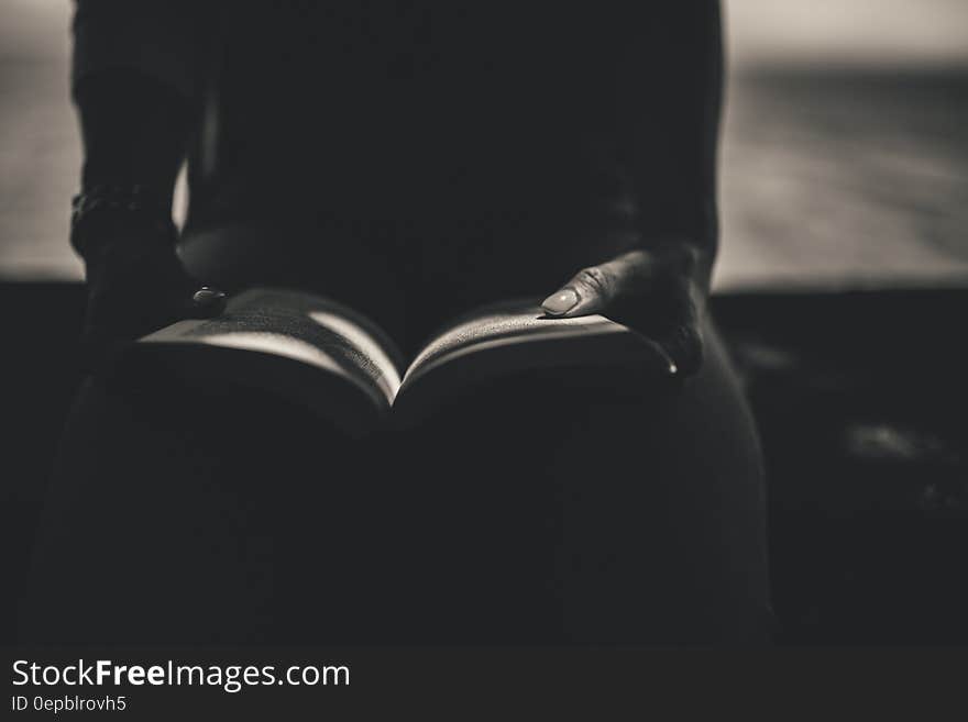 Person Sitting While Open the Book