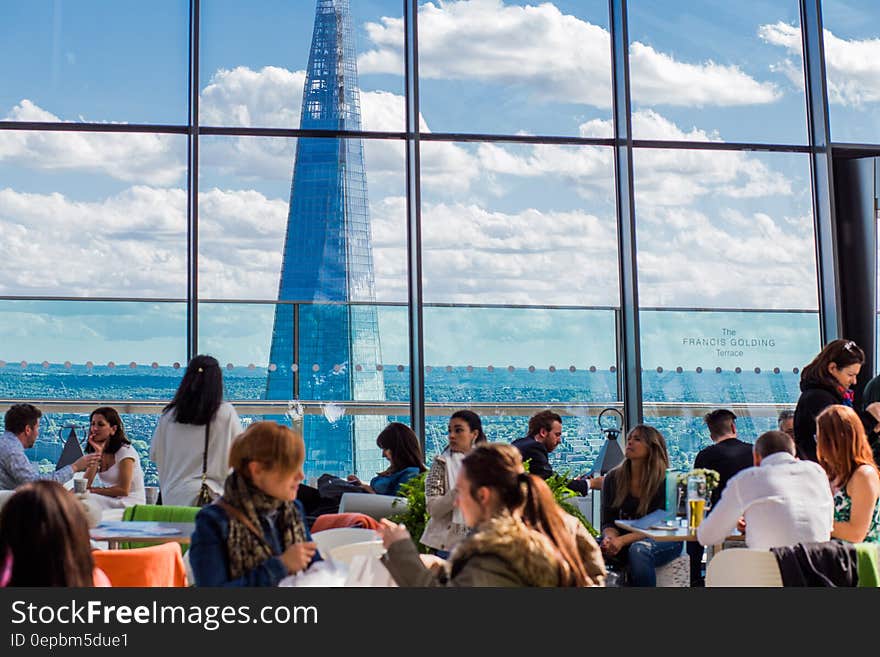 Diners seated at tables inside modern restaurant in downtown London, England. Diners seated at tables inside modern restaurant in downtown London, England.