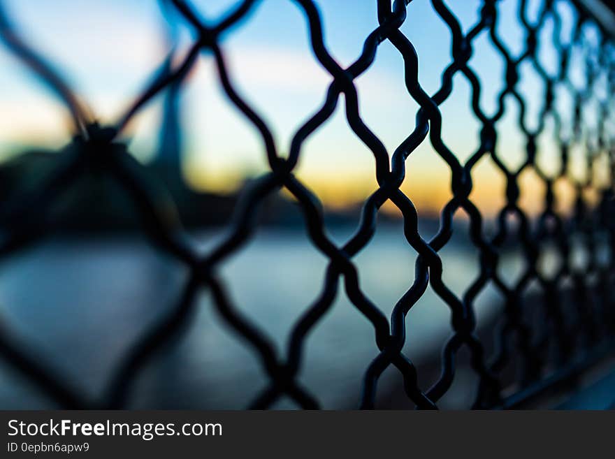 Close Photography and Tilt Lens of Black Chain Link Fence