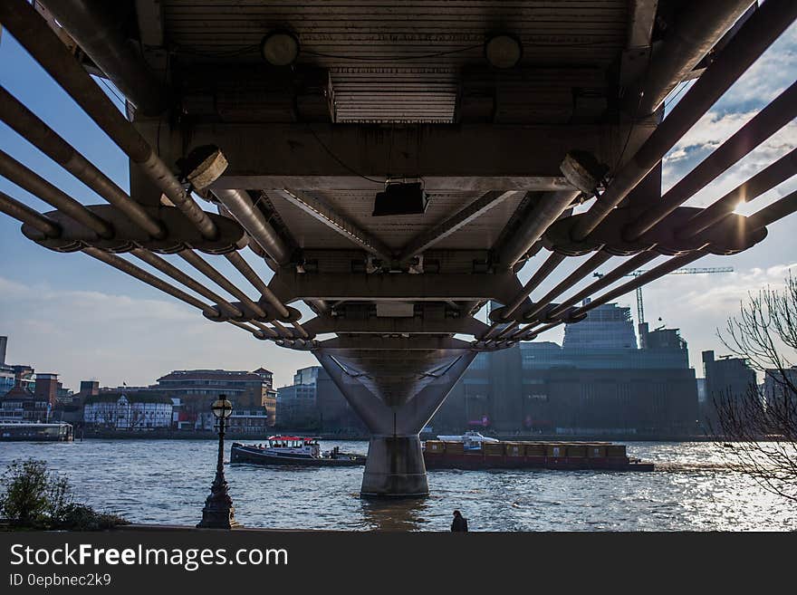 Underside of Millennium Bridge over River Thames in London, England on sunny day. Underside of Millennium Bridge over River Thames in London, England on sunny day.