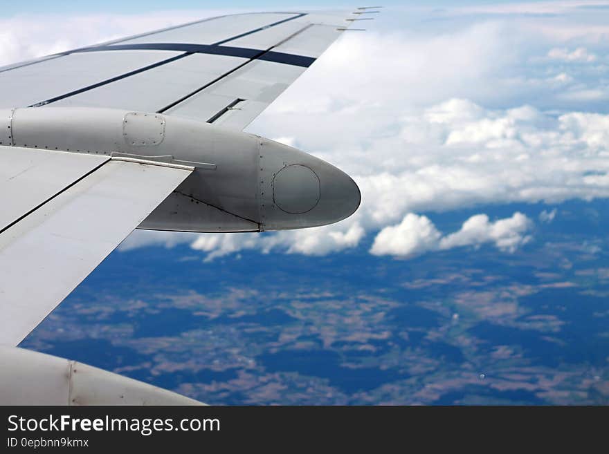 Airplane wing over rural landscape against blue skies. Airplane wing over rural landscape against blue skies.