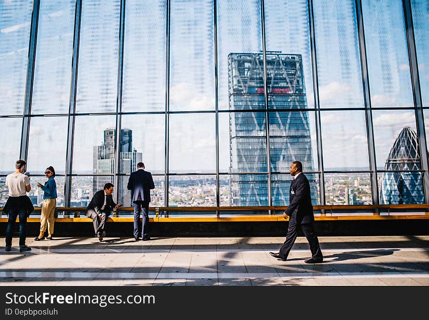 Visitors inside 20 Fenchurch in London, England with glass wall on sunny day. Visitors inside 20 Fenchurch in London, England with glass wall on sunny day.