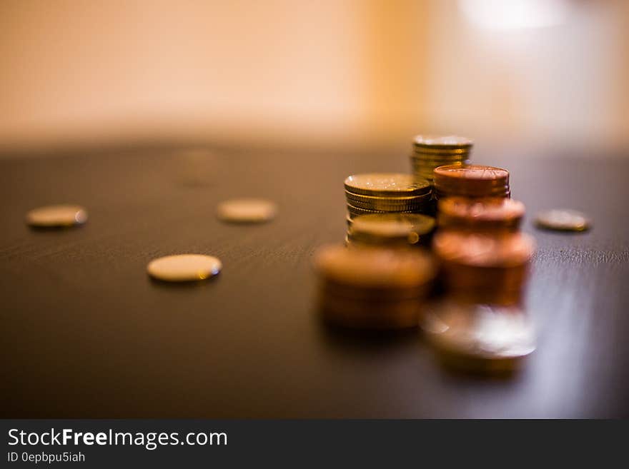 Close up of stacks of coins on wooden desktop. Close up of stacks of coins on wooden desktop.