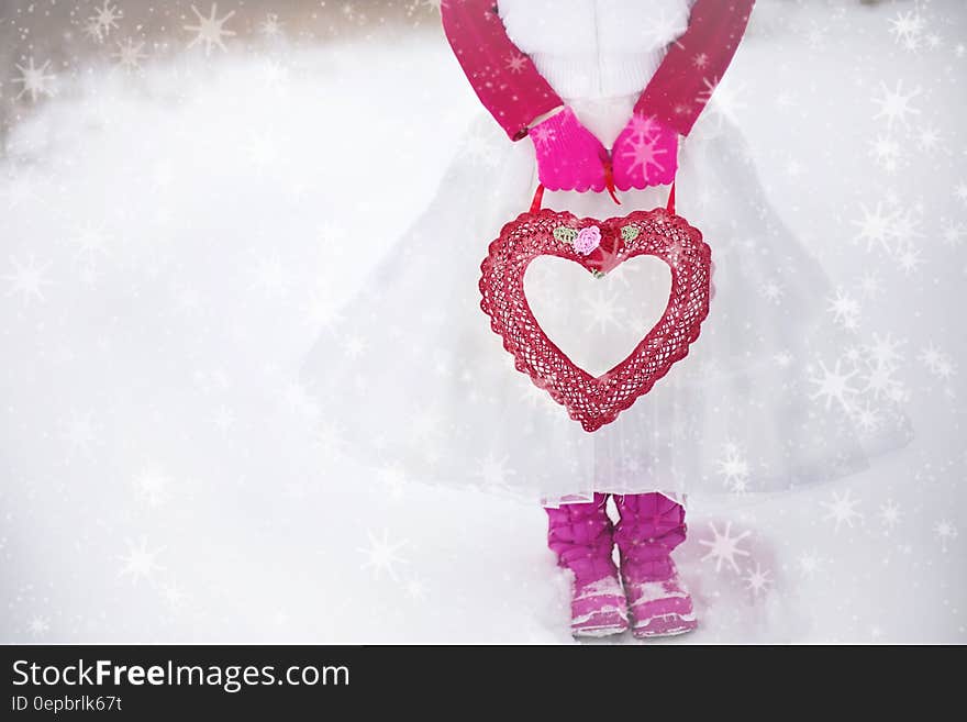 Person in Pink White Dress Holding Red Heart Purse