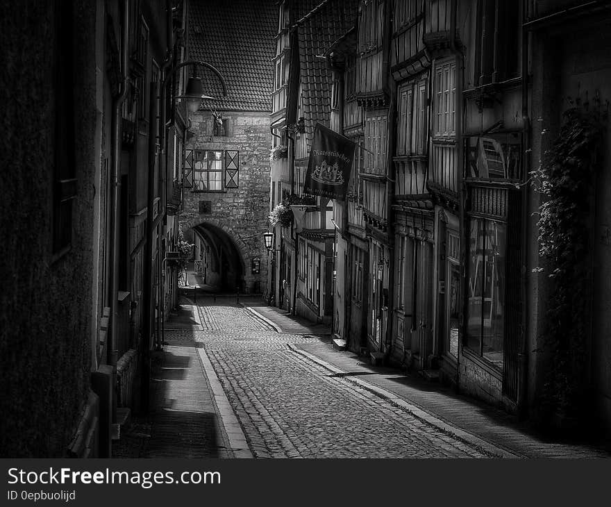 Exterior of medieval buildings on cobblestone streets at night in black and white. Exterior of medieval buildings on cobblestone streets at night in black and white.