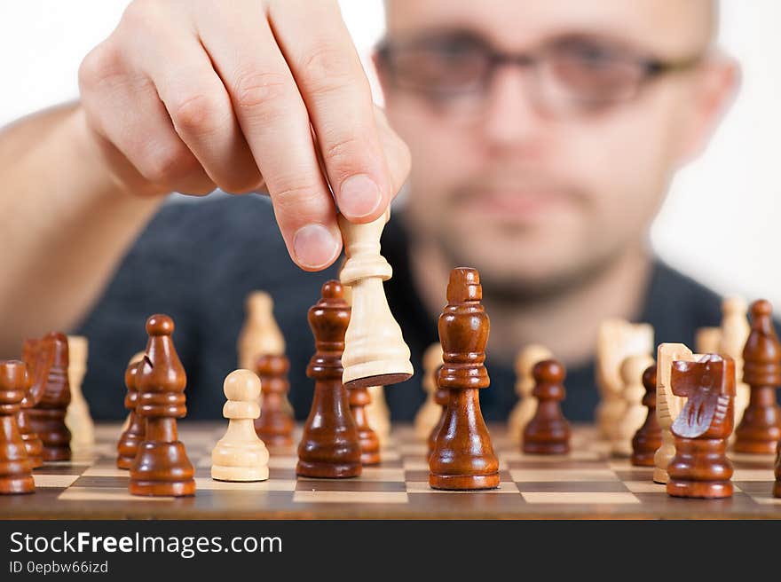 Man Holding Chess Piece