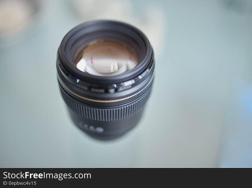 Close up of 85mm canon camera lens on blue. Close up of 85mm canon camera lens on blue.