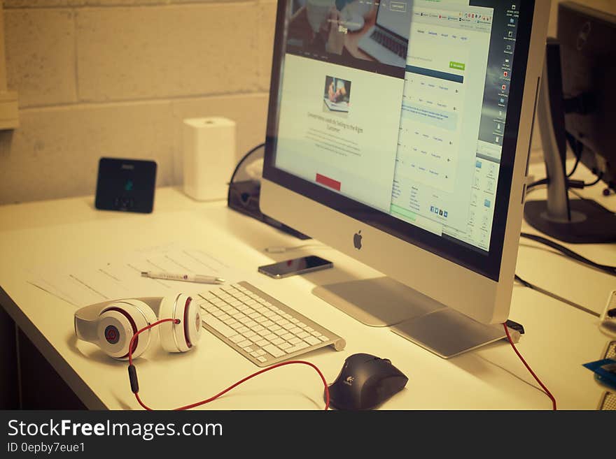 A computer and peripherals on a desk for a worker. A computer and peripherals on a desk for a worker.