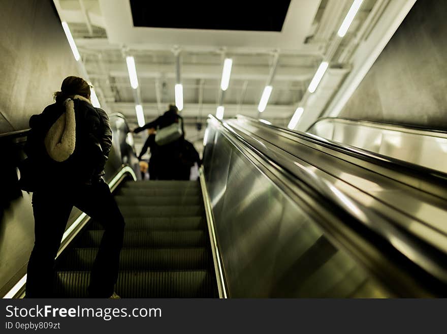 People walking up on an escalator.