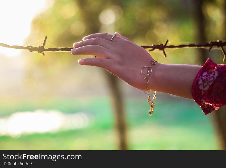 Left Persons Hand Holding a Bulb Wire