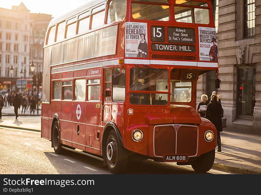 Number 15 London red bus traveling towards Tower Hill via Aldwych and St. Paul's cathedral stopped to pick up passengers in late afternoon golden sunshine. Number 15 London red bus traveling towards Tower Hill via Aldwych and St. Paul's cathedral stopped to pick up passengers in late afternoon golden sunshine.