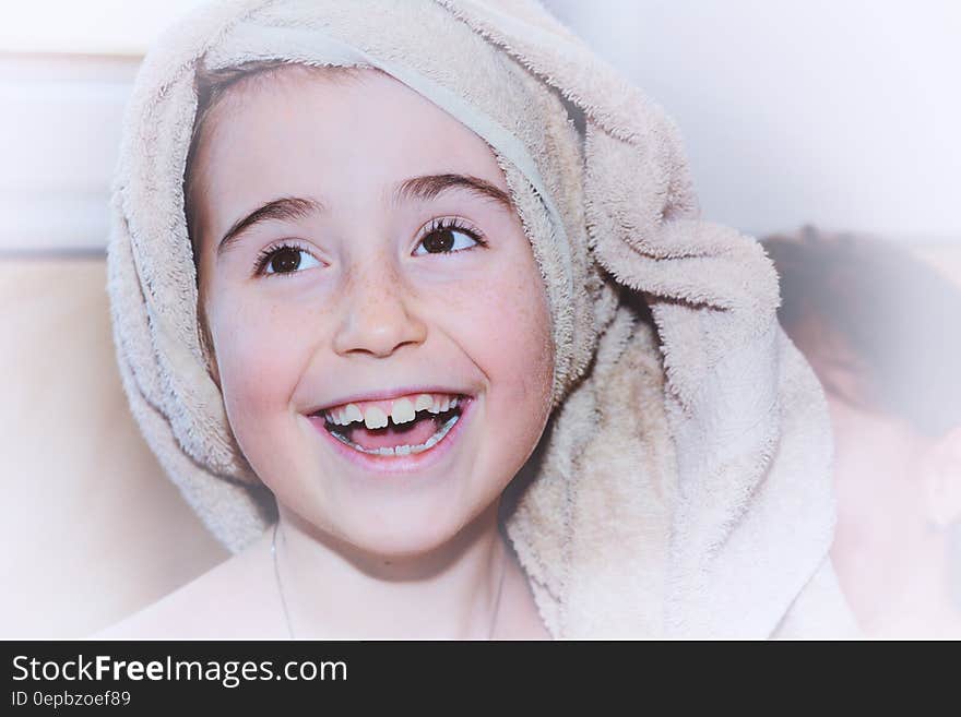 Portrait of young girl indoors smiling with terry cloth towel on head. Portrait of young girl indoors smiling with terry cloth towel on head.