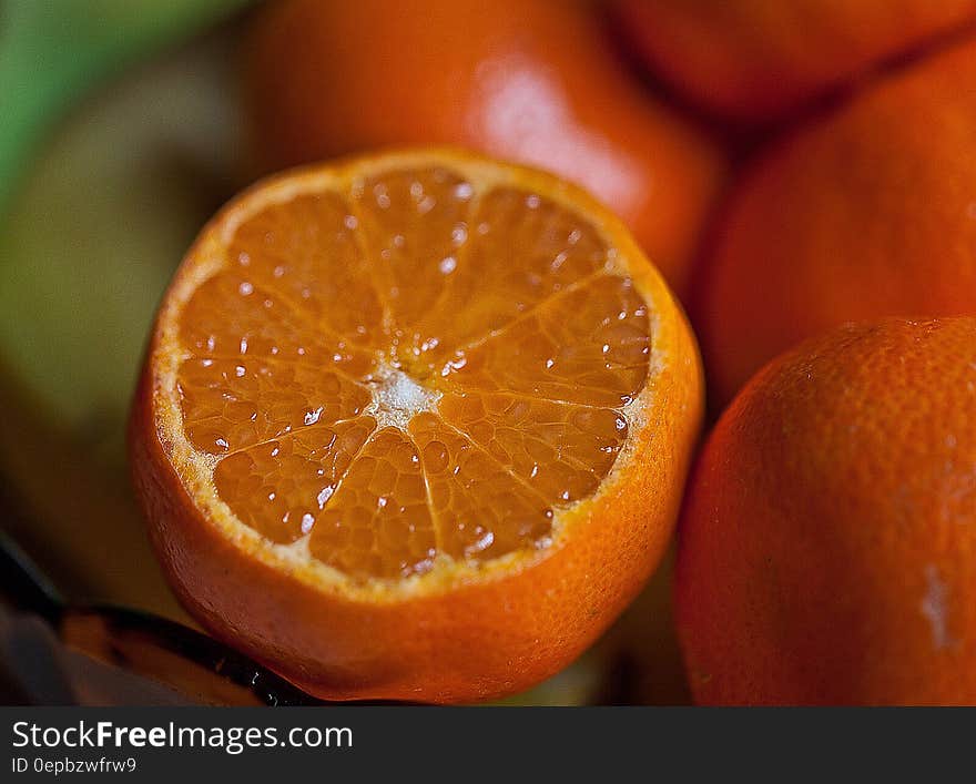 Fresh sliced orange close up with pile of fruits. Fresh sliced orange close up with pile of fruits.