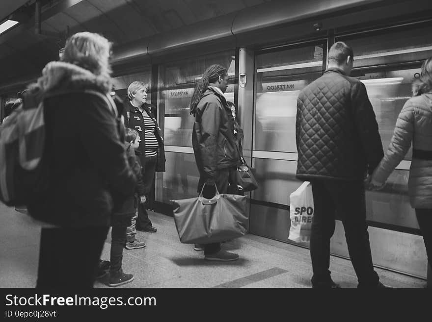 Man on Black Jacket Holding Woman on Brown Jacket