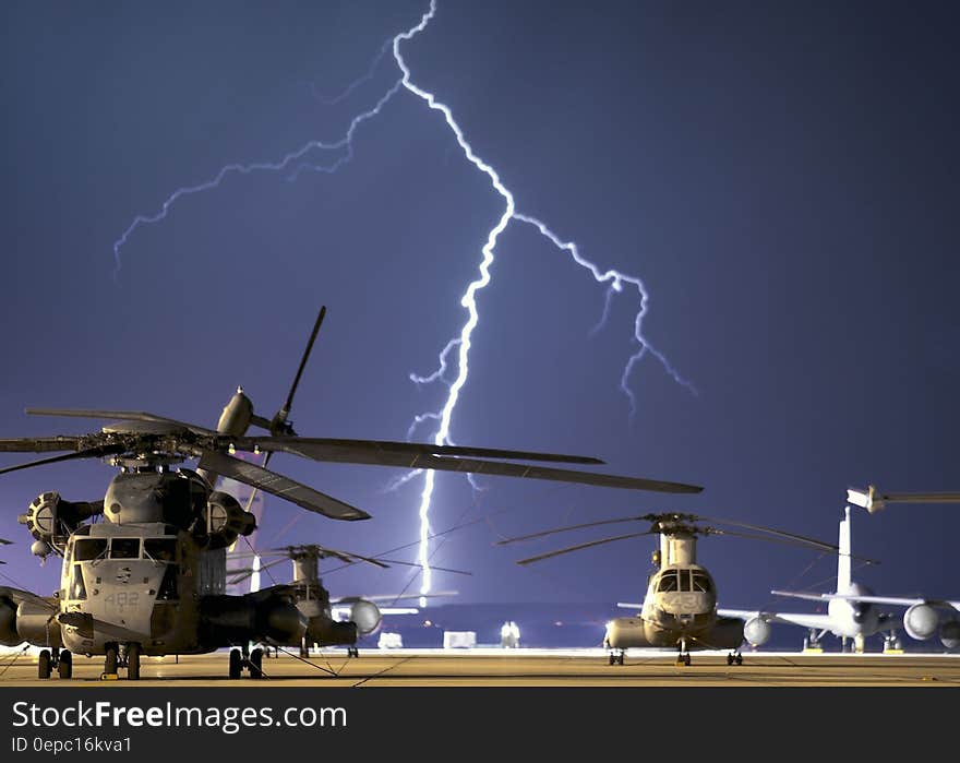 Lightning Near Grey Helicopter during Daytime