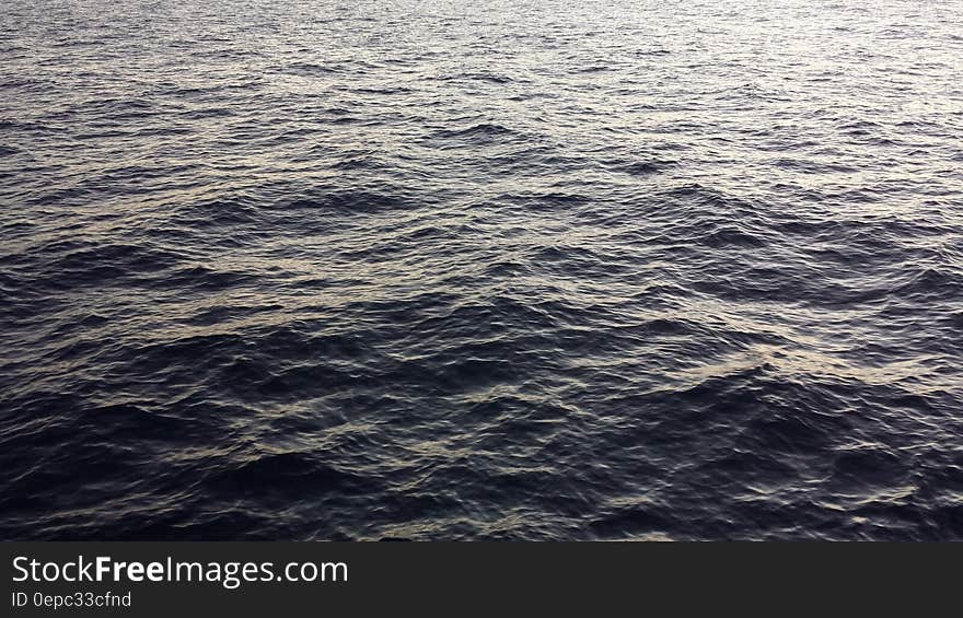 Waves in surface of water with sunshine. Waves in surface of water with sunshine.