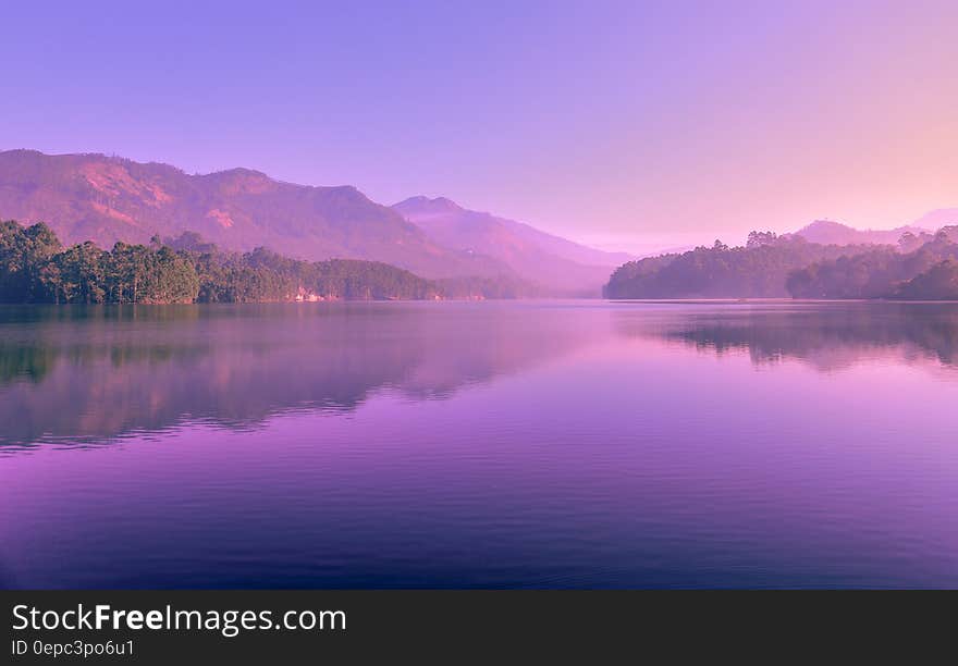 Purple skies at sunset reflecting in alpine lake. Purple skies at sunset reflecting in alpine lake.