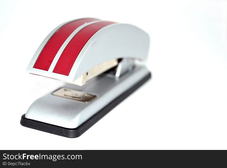 A red striped stapler on white background.