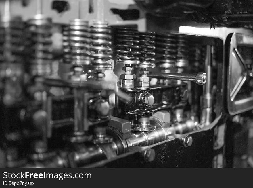 A close up of a engine cylinder head in black and white.