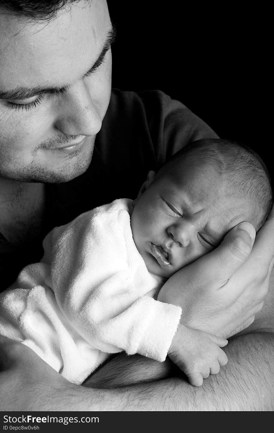 Grayscale Photo of Man Holding Baby