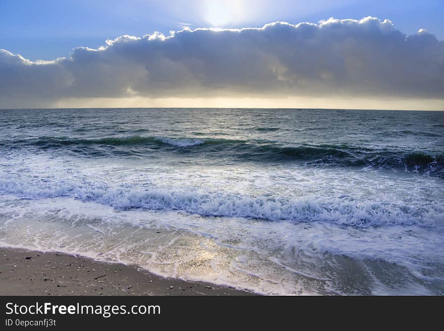 Ocean Under Blue Sky and White Clouds