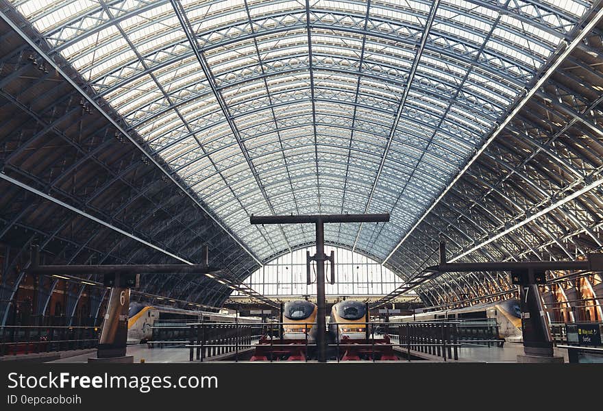 A train platform at a railway station with an arched ceiling.