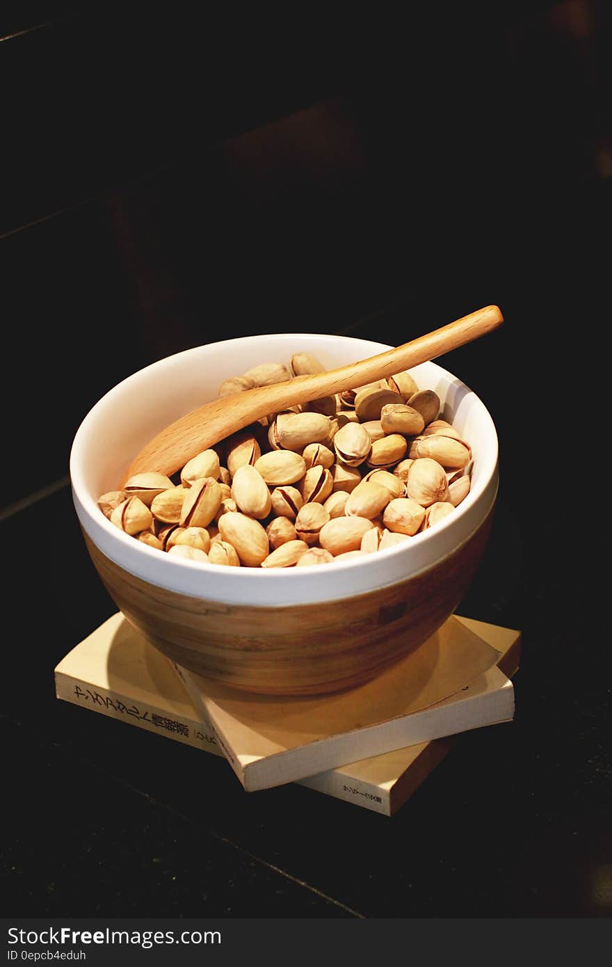 Pistachio Nuts in White and Brown Ceramic Bowl With Brown Wooden Spoon