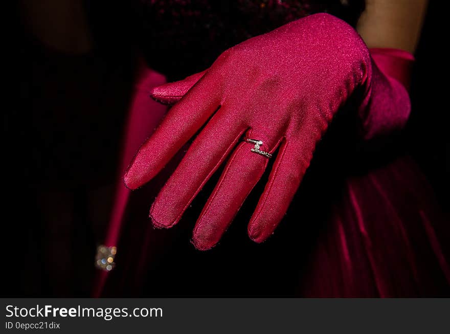 Person in Red Glove With Silver Ring