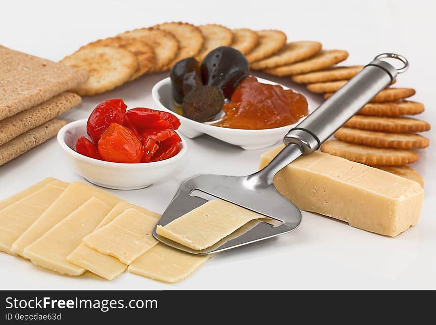 Hors d'oeuvre or savoury dish served as an appetizer and composed of cheese, dates, biscuits, black pudding and jelly, white background. Hors d'oeuvre or savoury dish served as an appetizer and composed of cheese, dates, biscuits, black pudding and jelly, white background.