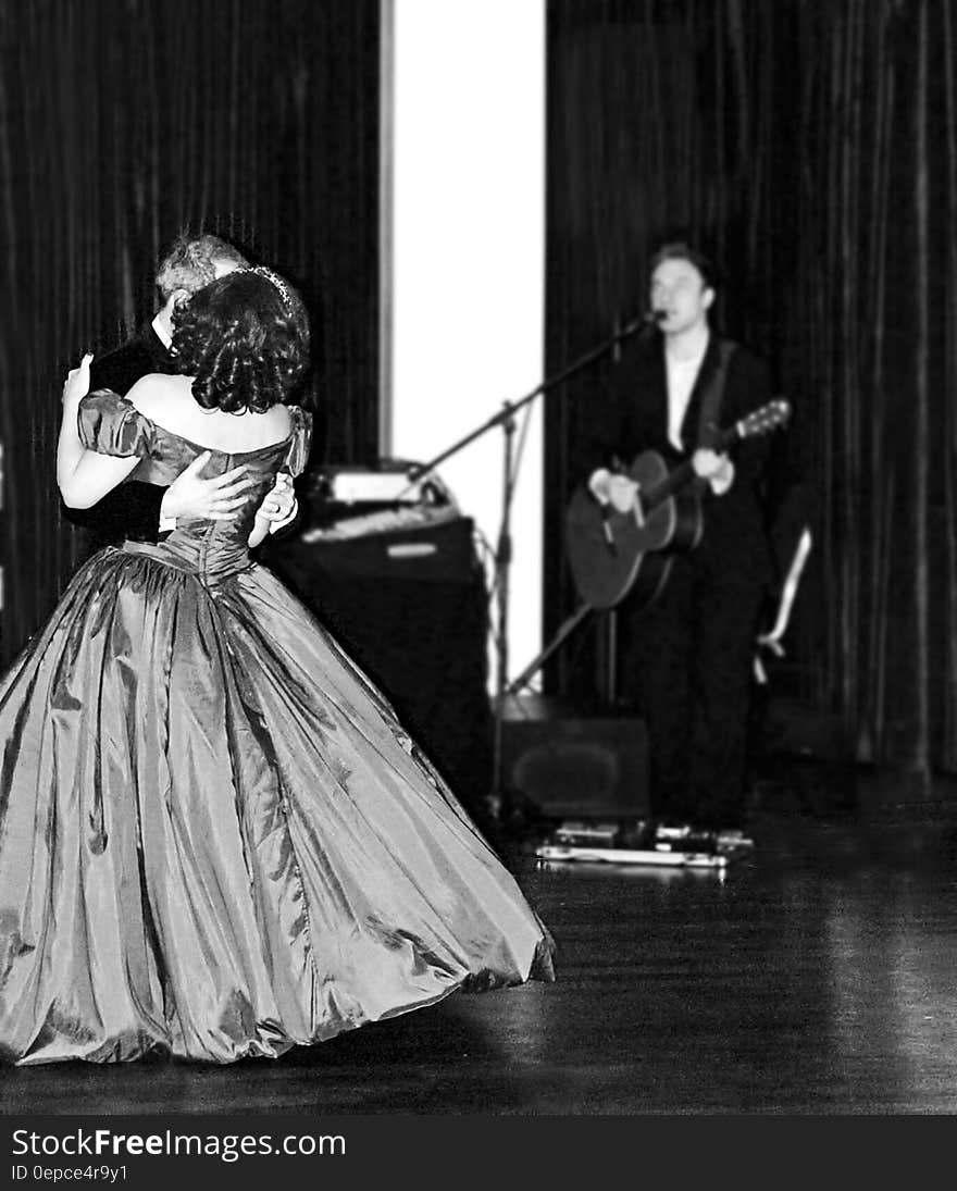 Man and Woman Dancing in Prom Apparel Near Man Singing