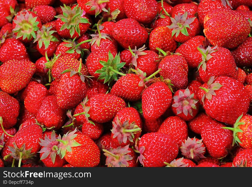 A pile of ripe red strawberries.