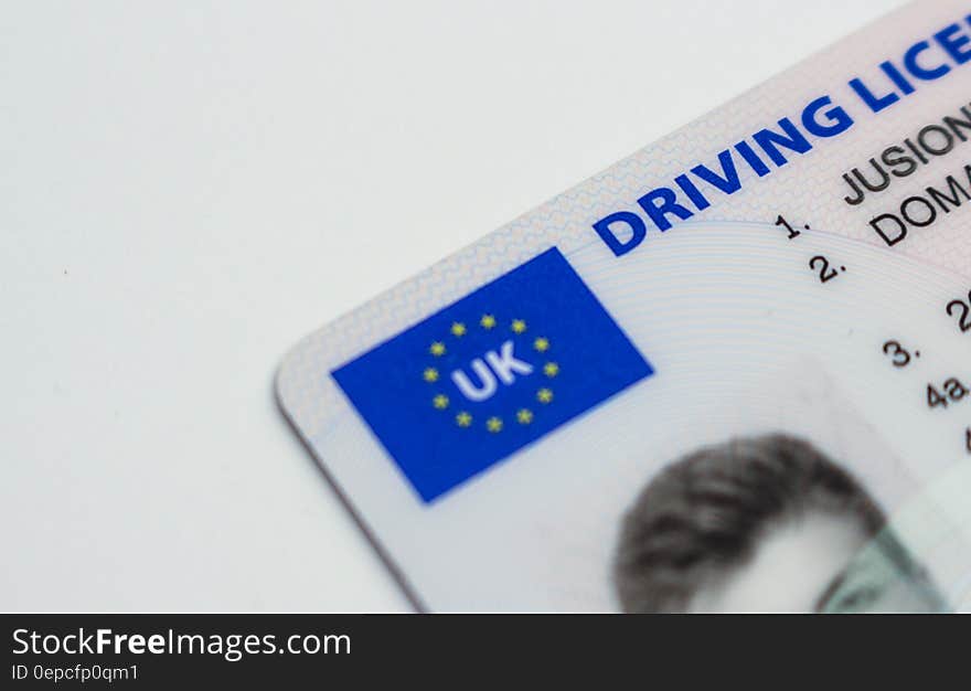 Close up of logo and front of UK drivers license.