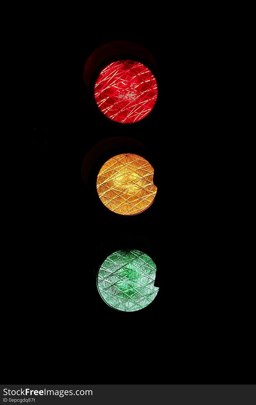 Red, yellow and green in traffic light on black.