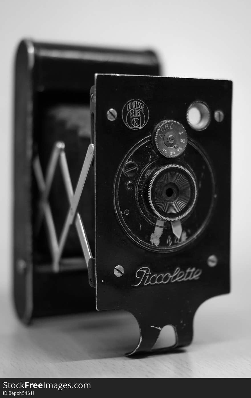 Vintage Piccolette camera lens in black and white.