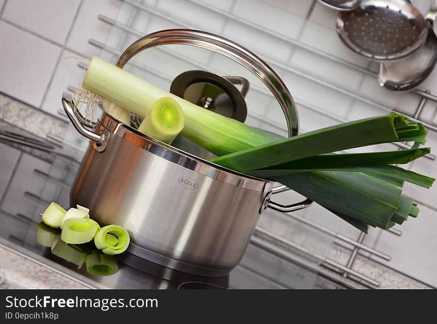 White and Green Vegetable on Top of Stainless Steel Cooking Pot