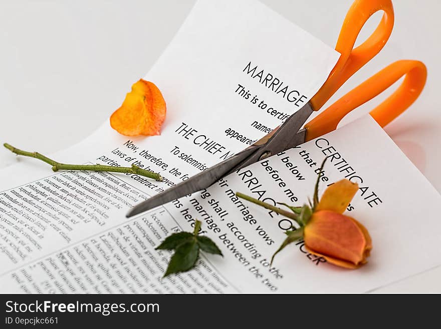 Printer Paper Cut With Orange Scissor