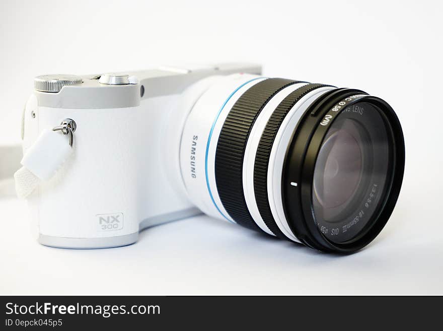 Closeup of Samsung NX300 digital camera on white background.