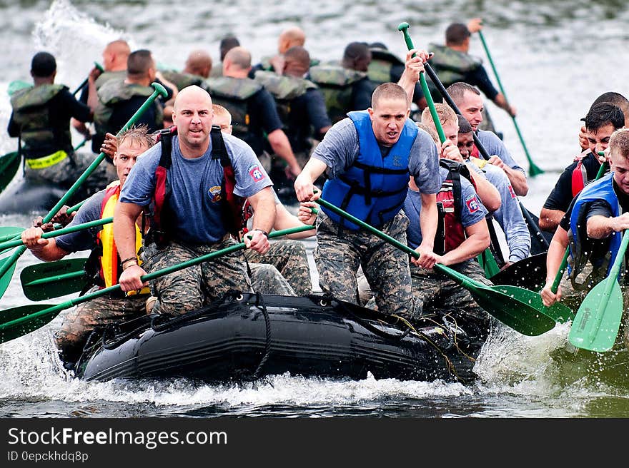 Men Paddling in Inflatable Raft Boat during Daytime