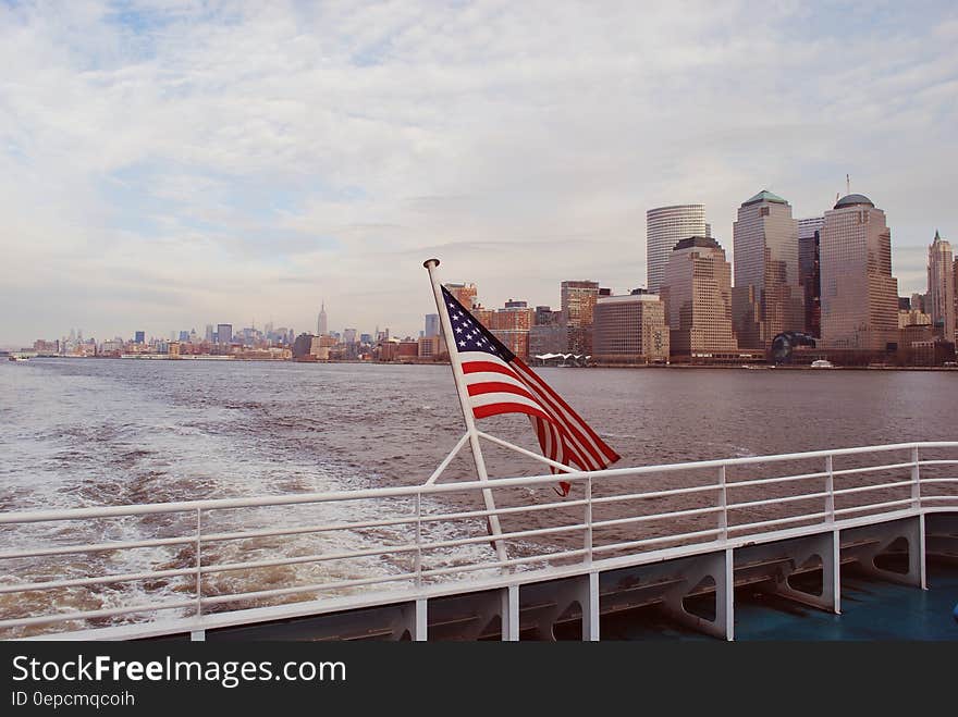 American flag on back of boat along waterfront of New York, NY. American flag on back of boat along waterfront of New York, NY.