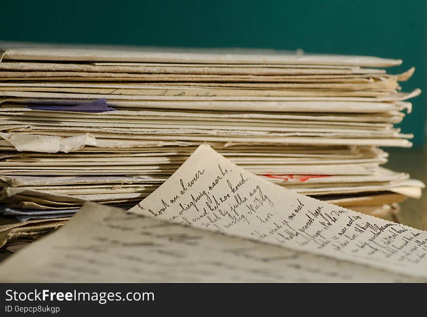 White Stacked Worksheets on Table