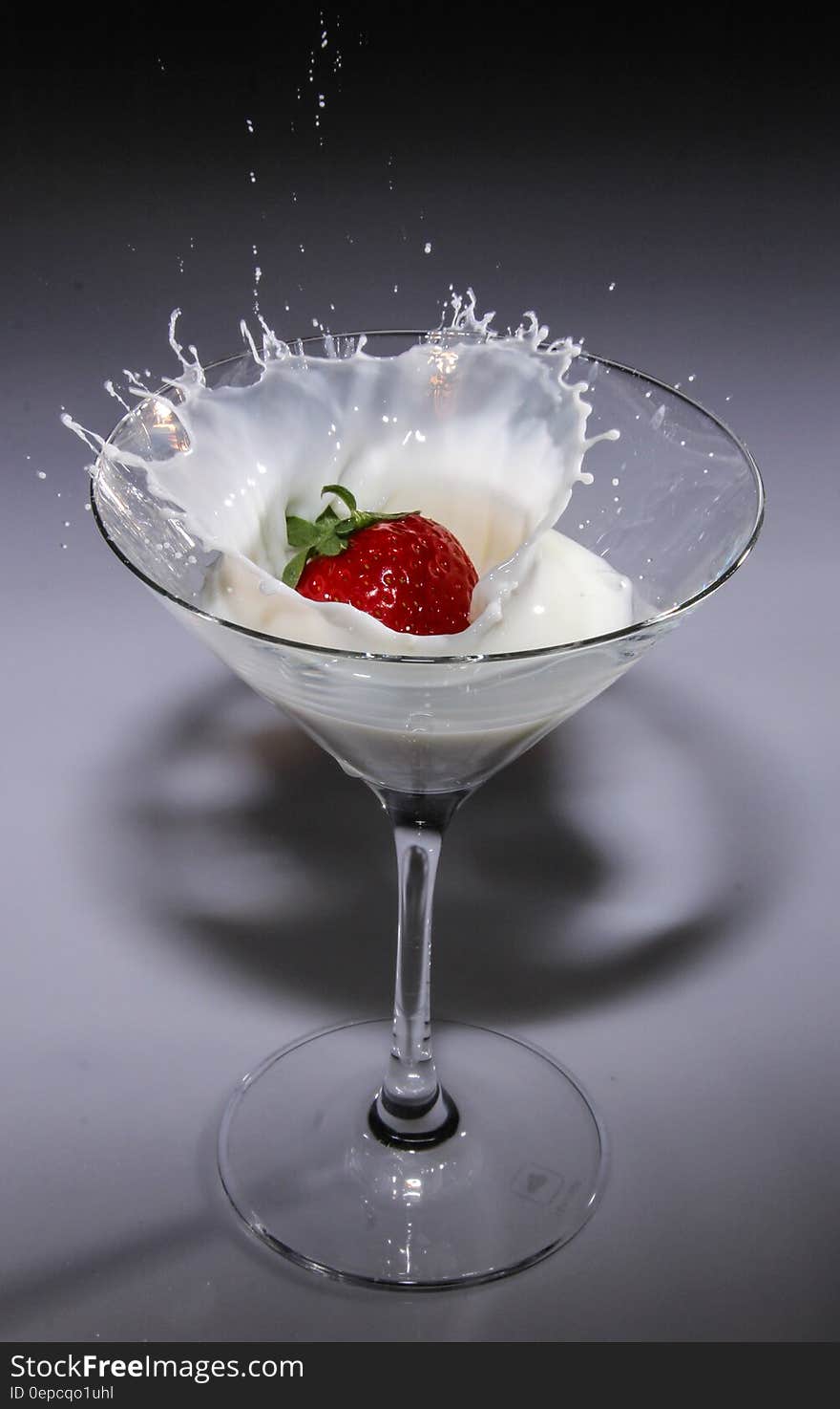 Clear Long Stem Wine Glass With Strawberry and White Liquid