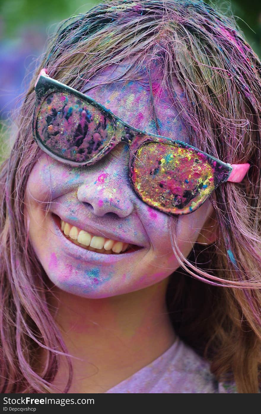 Girl in Black Framed Sunglasses With Color on Her Face from Color Run Smiling